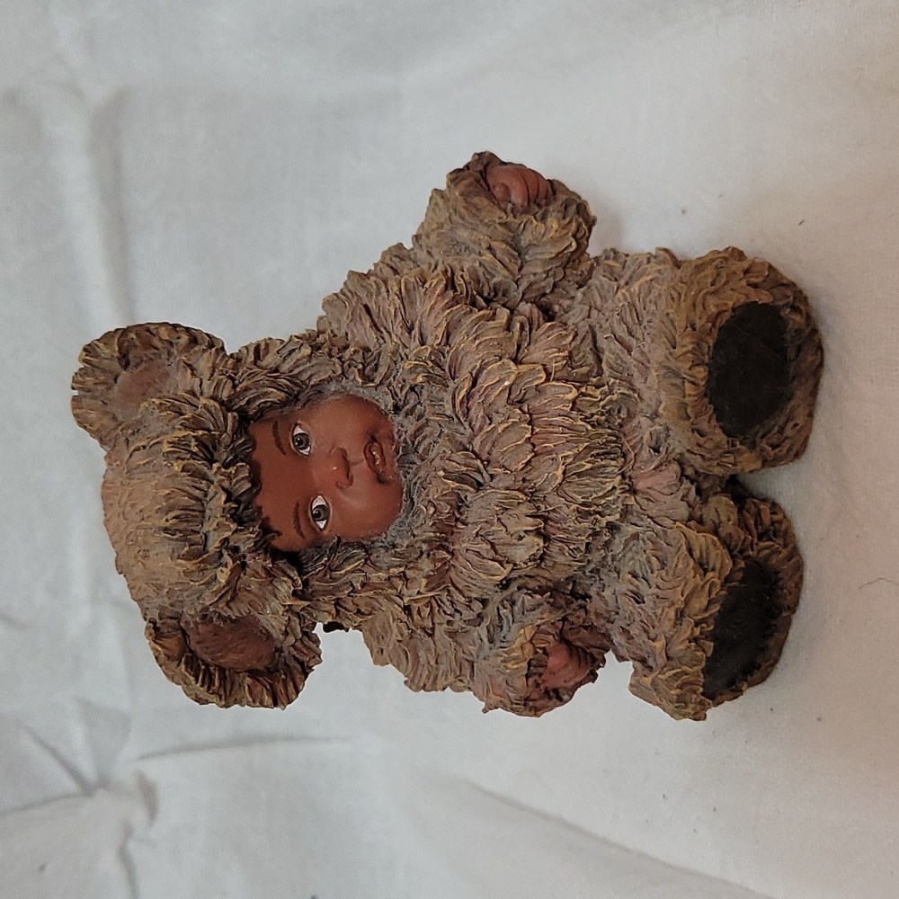 1998 Anne Geddes. Resin black baby in bear suit. "From small beginnings"